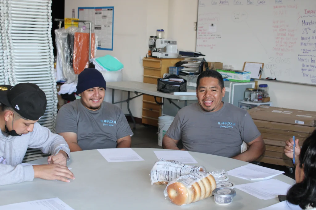 career and gardena jobs arent hard to find at Tlapazola here Team members smiling during company meeting; one completing training form.