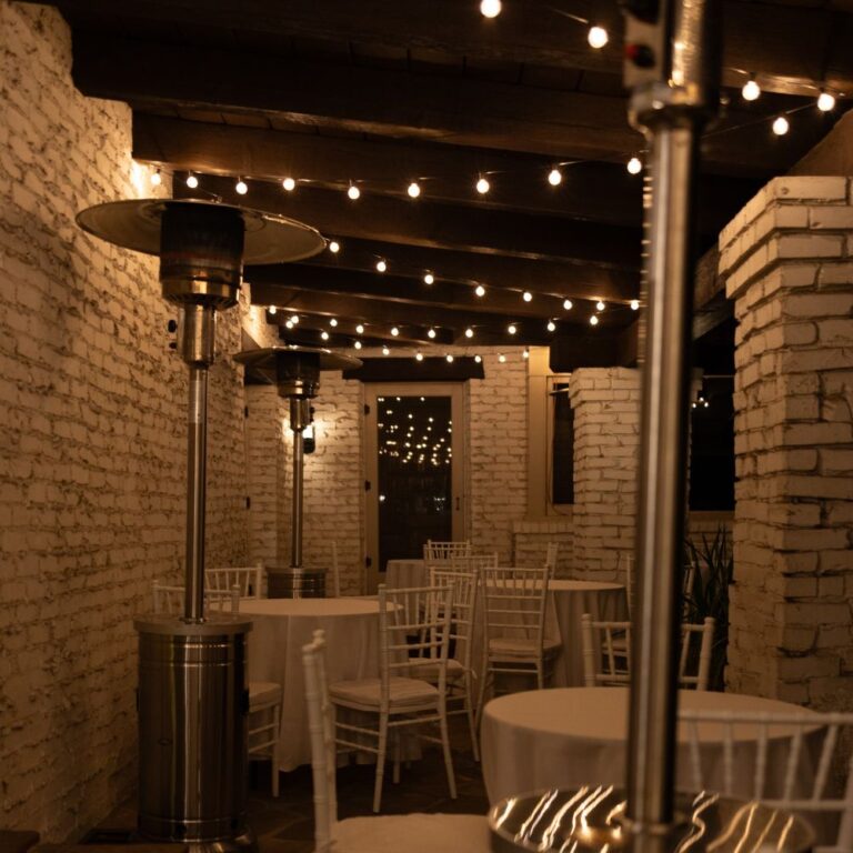 Outdoor event setup with patio heaters, string lights, and white Chiavari chairs by Tlapazola Event Rentals in Los Angeles.