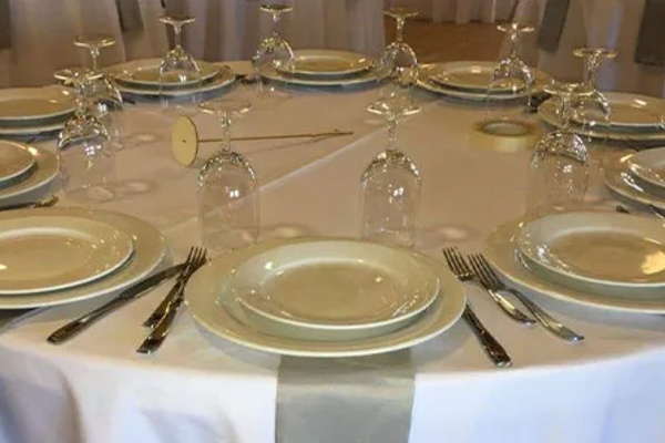 Elegant round table setup with premium china, glassware, and flatware for formal event rentals in Los Angeles